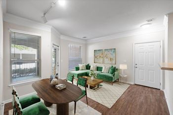 A living room with a green couch and a wooden table. at Somerset Oaks Apartment Homes, Kansas, 66062